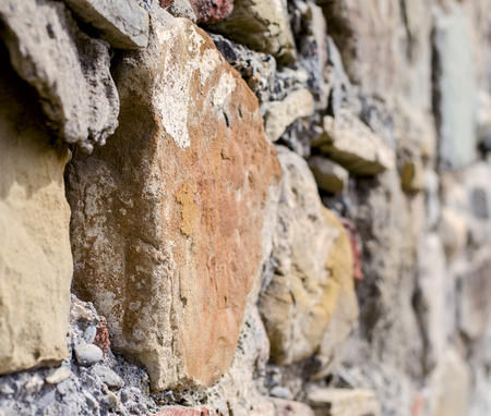 Stone in the wall with a blurry background. Close-up.の写真素材