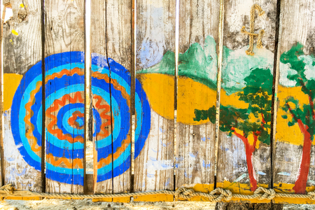 Multi-colored children's drawing on a wooden fence. Close-up.のeditorial素材