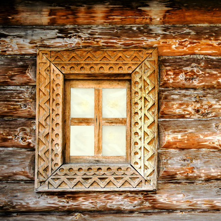 Old square wooden window. Detail of facade vintage rustic house. Can used as background. Close-up.の写真素材