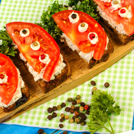 Fresh tomato and parsley, on roasted bread. Summer open sandwich. Can be used to demonstrate summer healthy vegetarian food. Square. Close-up.の写真素材