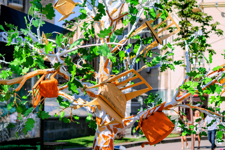 Kiev, Ukraine, August 2018: - Artificial tree, ornamented with decorative chairs instead of fruits. Close-up.のeditorial素材