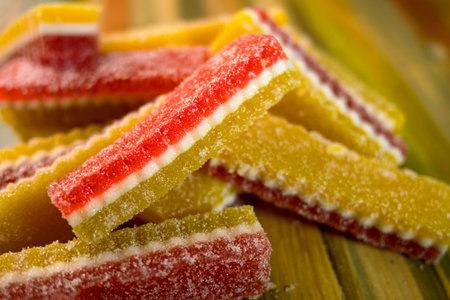 Multi-colored candy marmalade lie in pile on wooden background. Selective focus. Close-up.