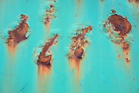 Blue old rusty wall  with damaged and weathered paint and corrosion. Close-up.の写真素材