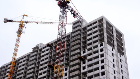 New multistorey residential building. Windows and walls in a house under construction. Modern civil...