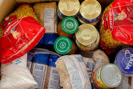 Kiev, Ukraine, April 2019: - Food reserve for survival, in box, during self-isolation during epidemic of coronavirus covid-19 in household. Close-up.のeditorial素材