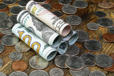 American dollars banknotes rolled into tube and us coins. Cash and savings of financial assets and home finance during the economic crisis. close-up.の写真素材