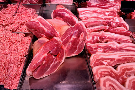 Quality various fresh raw pork meat in fridge showcase at modern butcher shop. Meat counter....
