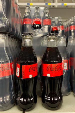 Kyiv, Ukraine, September 24, 2023: - Classic Coca-Cola in stylish glass bottle packaged in row for...