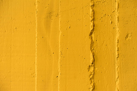 Yellow concrete wall texture with interesting surface.Close-up.の写真素材
