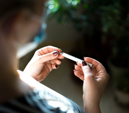 A girl holds thermometer. Stay at home. Stay safe. Shallow depth of field.