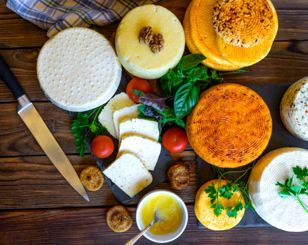 Cheese Heads with cheeses of different kinds. Assortment of different cheese types on wooden...