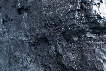 Shimmering edge of big chunk of black coal. Royalty free stock photo.
