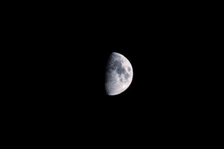 Zoomed in view of increasing half moon showing the craters on the surface. Royalty free stock photo.の写真素材