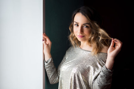 portrait of a beautiful young woman in a shiny top