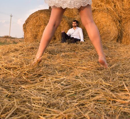 the groom sits between the legs of the brideの写真素材