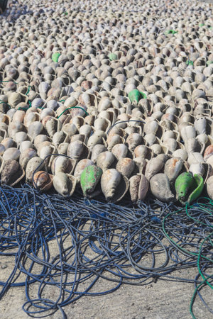 Fishing nets piled up on the ground at a fishing port.の写真素材
