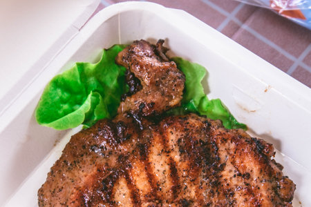Pork steak ready to be delivered in a food boxの写真素材