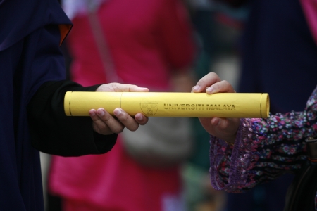 couple holding certificate from graduationのeditorial素材