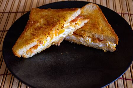 Sandwich with Egg, Bacon, Cheese and Spicy Sauceの写真素材