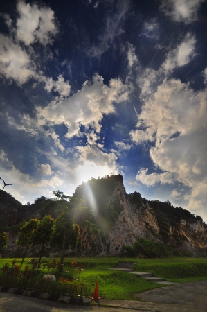 marching cloud with rising sun over the hillの写真素材