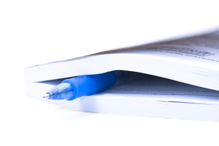 Closed Book And Blue pen Over White backgroundの写真素材