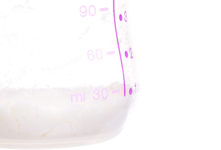 Close Up Of Milk Powder In The Milk Bottle With Measurement Isolated On Whiteの写真素材