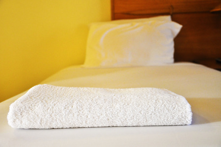 The Bath towels on the bed of hotel bedroomの写真素材