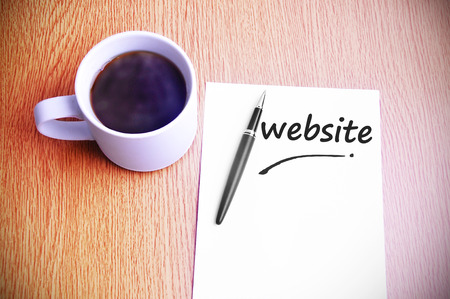 Business Concept  Steamy Coffee And Black Pen With White Paper Written Website.の写真素材
