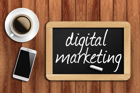 coffee phone and chalkboard with digital marketing words.の写真素材