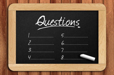 Chalkboard on the wooden table written questions list.の写真素材