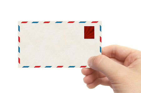 Hand holding envelope isolated on white - email concept.