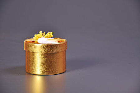 Golden gift box with grey background.の写真素材
