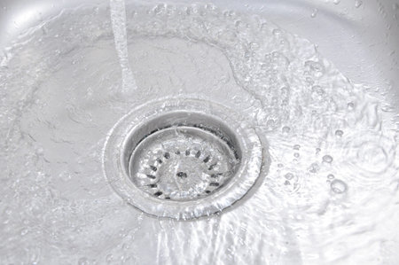 The Water Flowing Down In The Hole In A Kitchen Sink