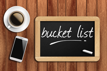 coffee, phone  and chalkboard with  word bucket list.の写真素材