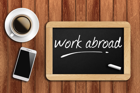 The coffee, phone  and chalkboard with  word work abroadの写真素材
