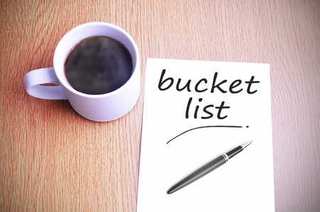 Black coffee on the table with note writing bucket listの写真素材