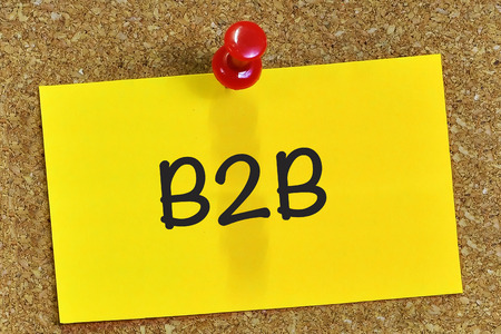 Business to business (B2B) on notepaper with cork background.の写真素材