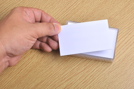 Hand hold blank mockup business card for branding and logo printing.の写真素材