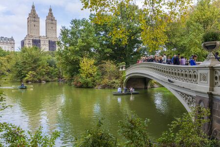 NEW YORK CITY / USA â OCTOBER 12, 2019: Panoramic view of the famous Bow Bridge in Autumn, The San Remo Building, Upper West Side, from Central Park, Manhattan, New York Cityのeditorial素材