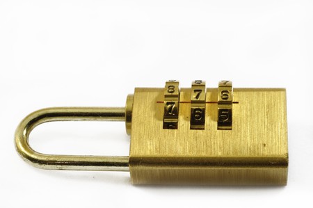 Brass yellow gold combination lock on a white backgroundの写真素材