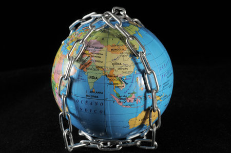World in chains that represents the crisis on a black backgound 