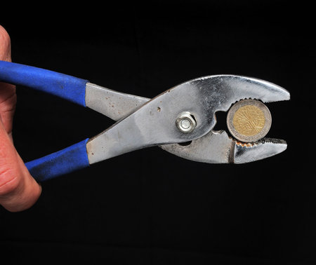 Strong Pliers and Money on a Black Backgroundの写真素材