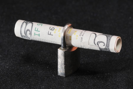 Banknote and a Metal Lock on a Black Backgroundの写真素材