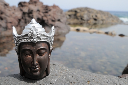 One Ancient Gray Buddha Statue Near The Oceanの写真素材