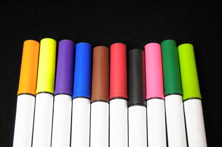 Some Colored Ink Markers on a Black Backgroundの写真素材