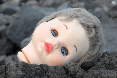 One Ancient Dool's Head Abandoned on the Rocksの写真素材