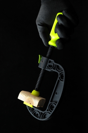 Pliers and a Hand on a Black Backgroundの写真素材