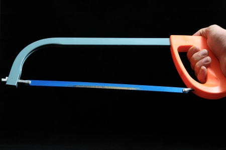 Saw and a Hand on a Black Backgroundの写真素材