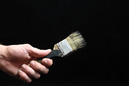 Brush  and a Hand on a Black Backgroundの写真素材