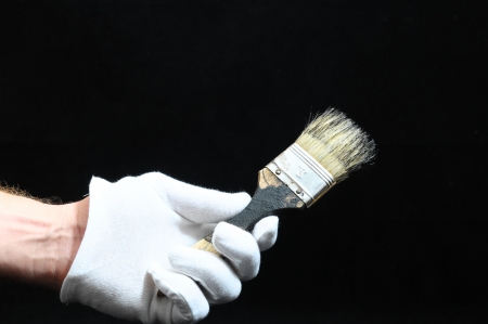 Brush  and a Hand on a Black Backgroundの写真素材